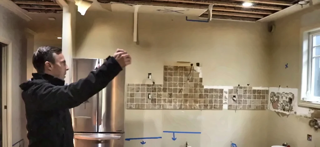 North Fort Myers water damage restoration: inspector checking a kitchen with cabinets removed during water damage restoration