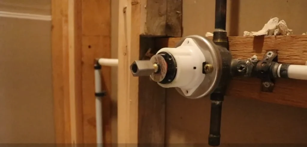Burst pipe cleanup Fort Myers: burst pipe cleanup in Fort Myers: shower valve and supply pipes exposed behind an opened wall