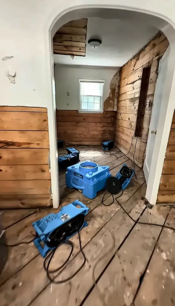 Water damage restoration Estero FL: water damage restoration in Estero: flood cut hallway wall with an air mover drying