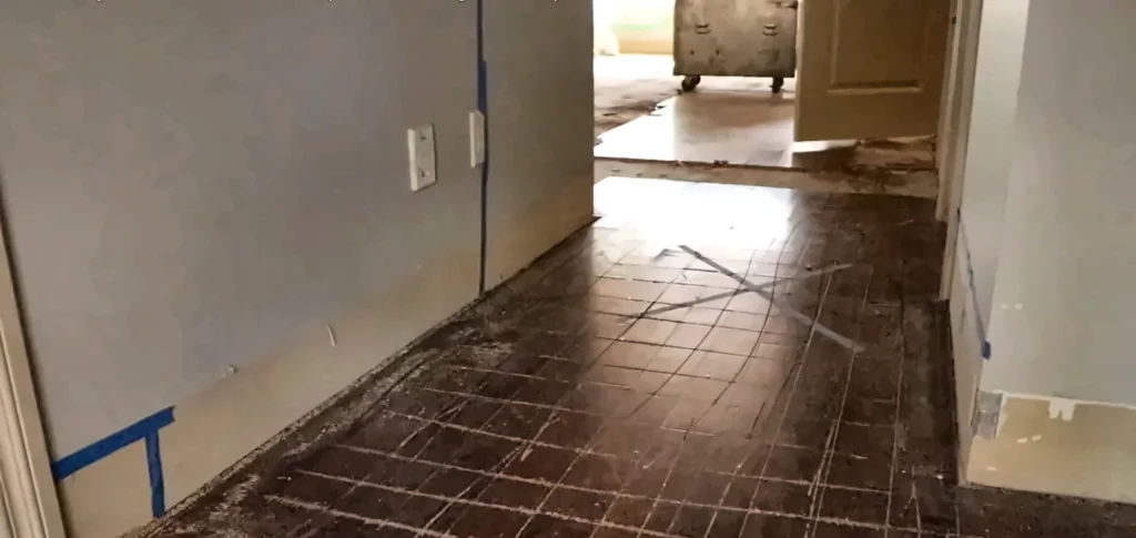 Water damage restoration Estero: drying equipment on a tile hallway during water damage restoration