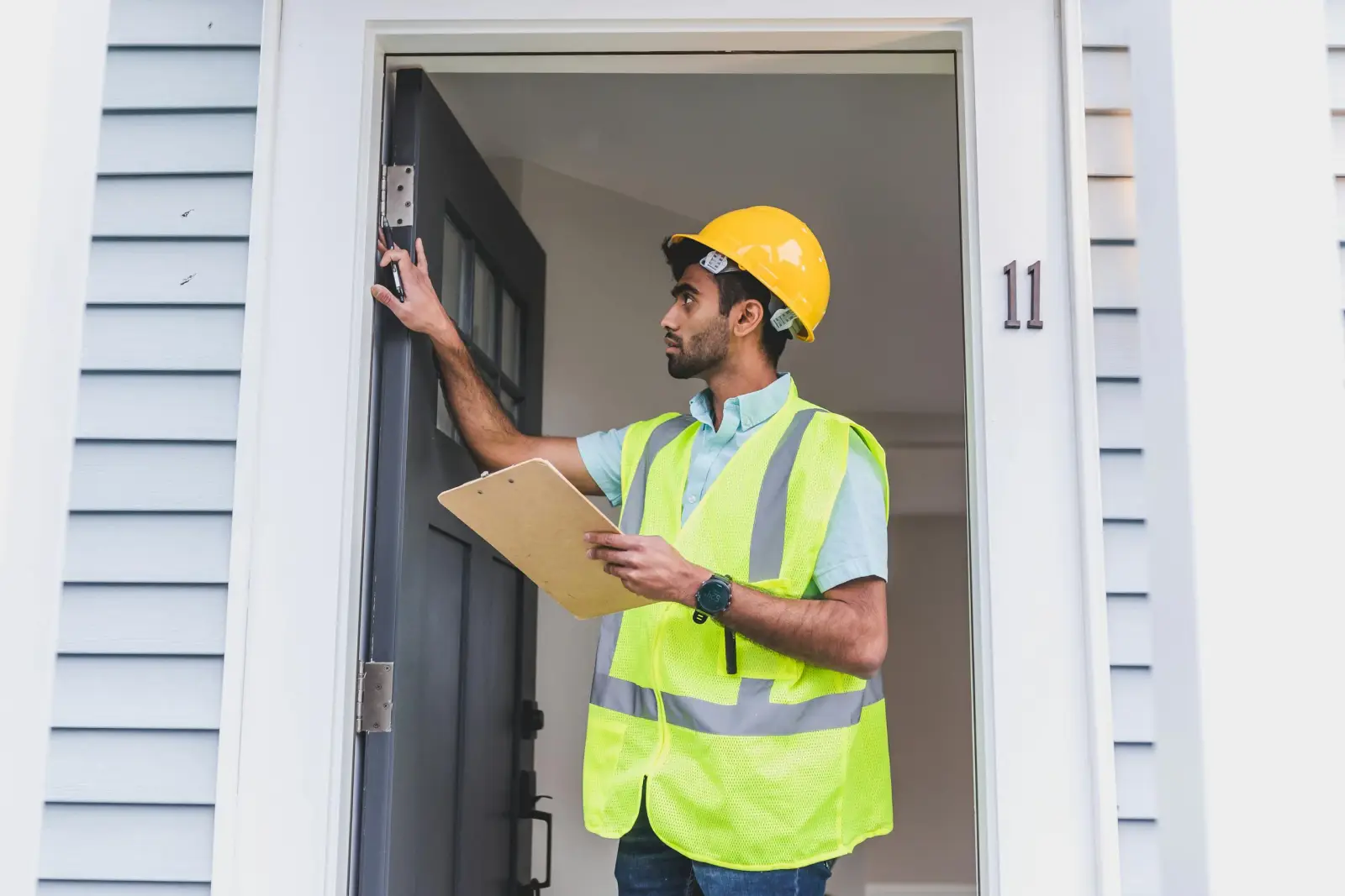 Inspector checking a doorframe for moisture, from our Fort Myers water damage resources
