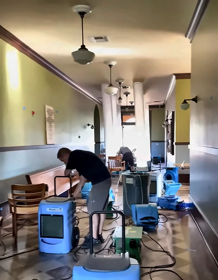 Water damage restoration Naples Florida: dehumidifier drying a room