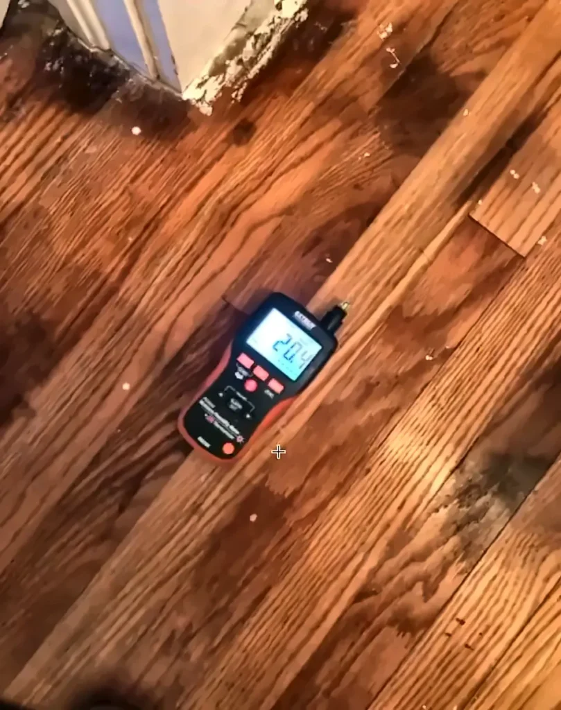 Water damage restoration North Fort Myers: moisture meter checking a floor during water damage restoration