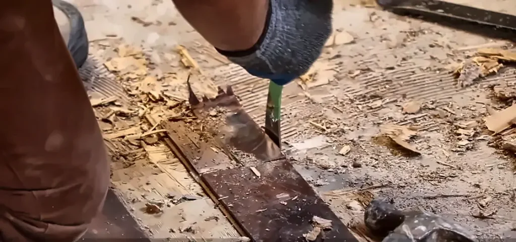 Water damage repair Fort Myers FL: crew removing wet hardwood flooring before repairs
